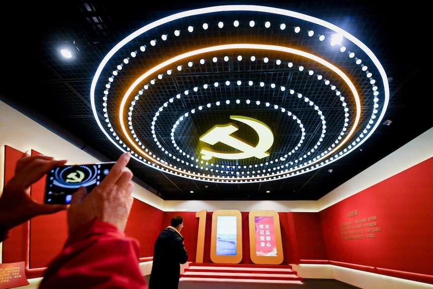 People visit an exhibition to mark the 100th founding anniversary of the CCP at a museum.