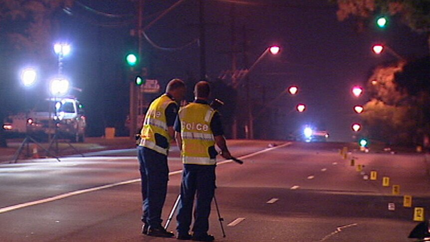 Police gather evidence after a pedestrian was killed