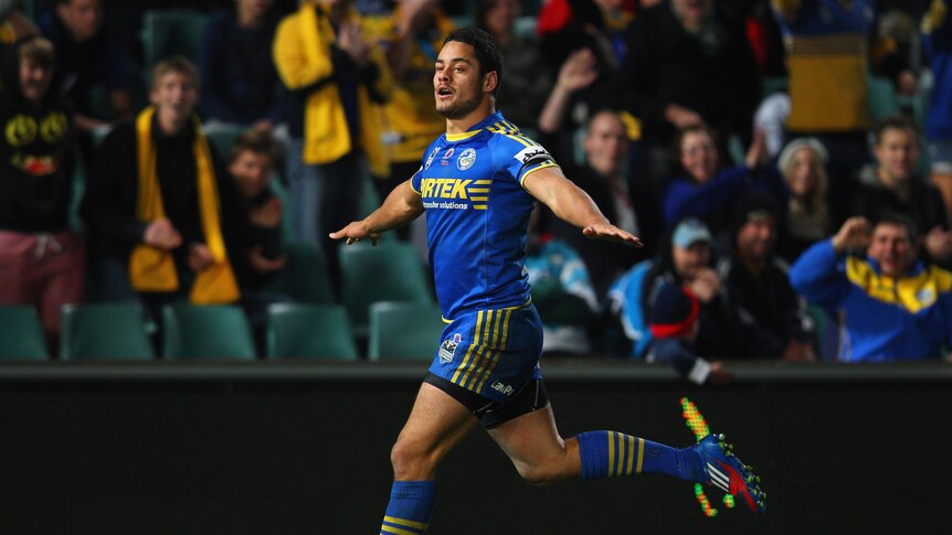 Flying again ... Jarryd Hayne celebrates his second try against the Sharks.
