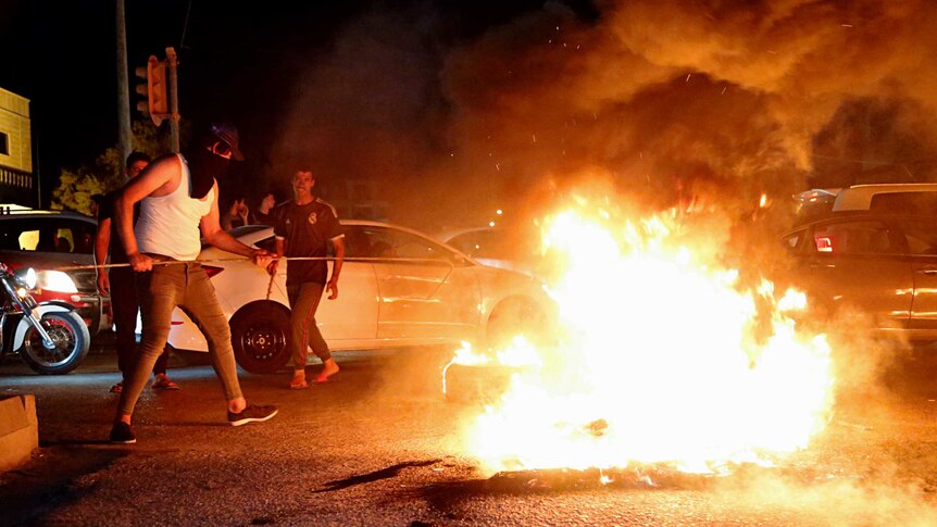 Iraqi protesters demanding services and jobs burn tires