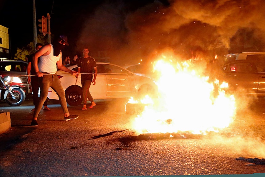 Iraqi protesters demanding services and jobs burn tires