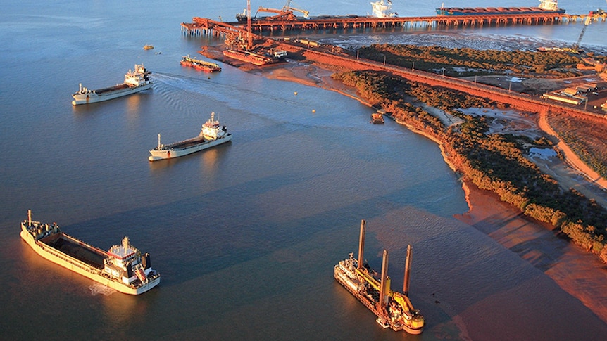 An aerial shot of large ships and facilities in the port of Port Hedland.