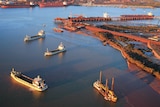 An aerial shot of large ships and facilities in the port of Port Hedland.