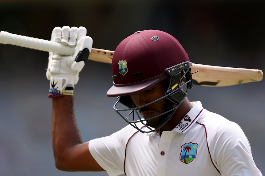 Kraigg Brathwaite holds his bat over his shoulder and looks down