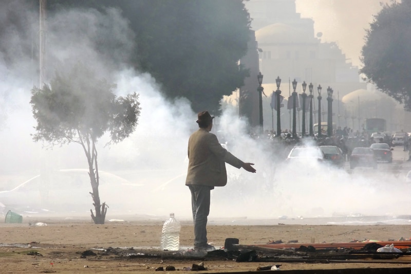 Man stands in Tahrir Square as protests rage