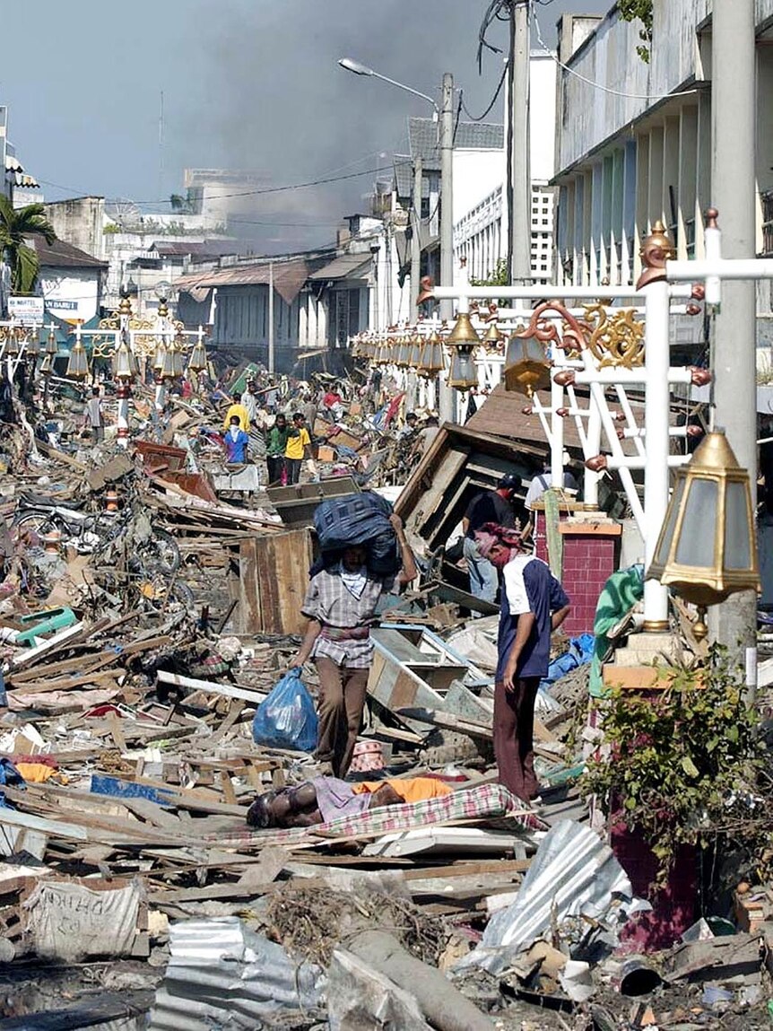 Residents in Aceh sift through rubble after the 2004 tsunami