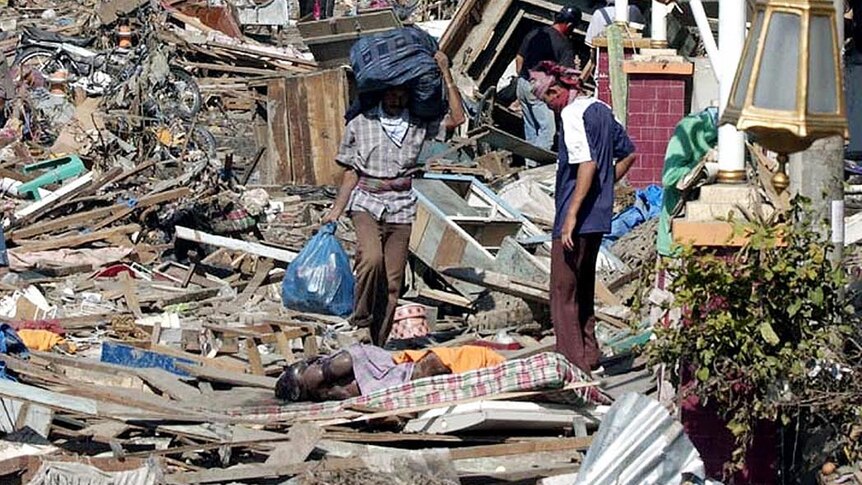 Residents in Aceh sift through rubble after the 2004 tsunami