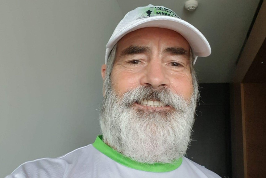 A marathon runner in hotel room where he ran a marathon.