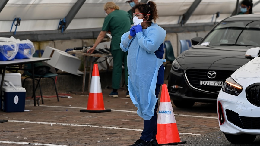a woman wearing a mask at a carpark testing clinic