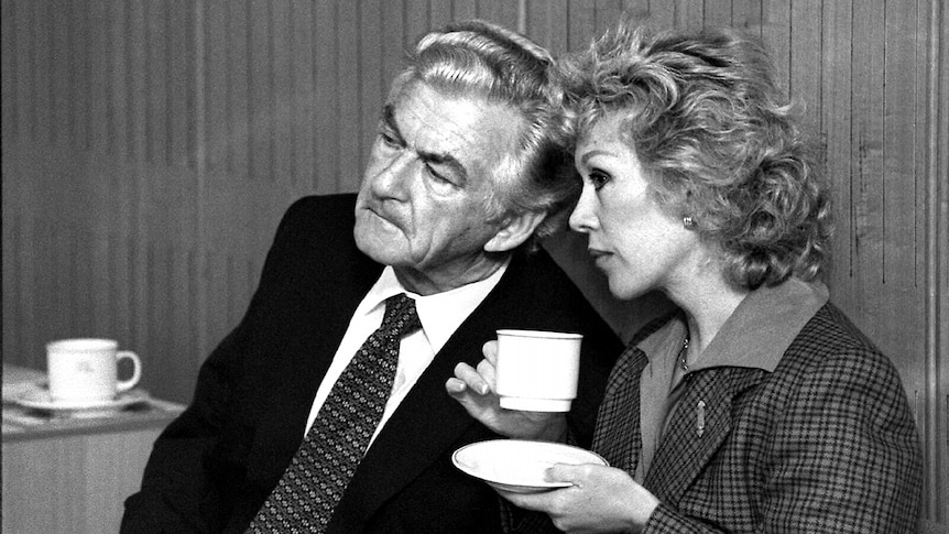 B&W pic of Bob Hawke and Blanche D'Alpuget drinking tea while giving evidence to a Senate Inquiry