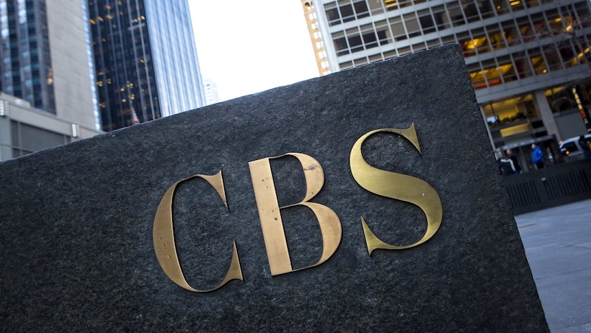 The CBS 'eye' logo on the side of a granite building.