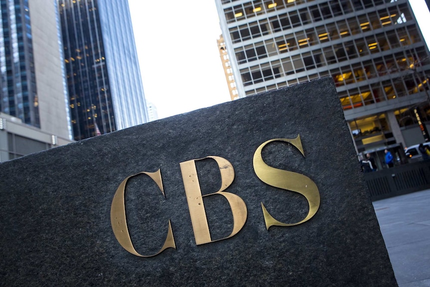 The CBS 'eye' logo on the side of a granite building.