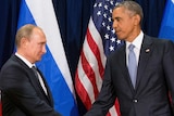 Russian President Vladimir Putin shakes hands with US President Barack Obama