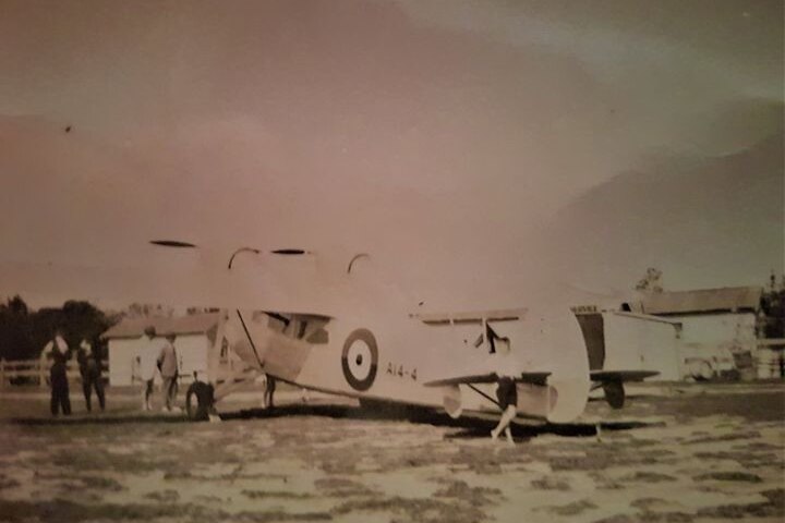 A black and white image from 1939 of a light aircraft on an air strip.