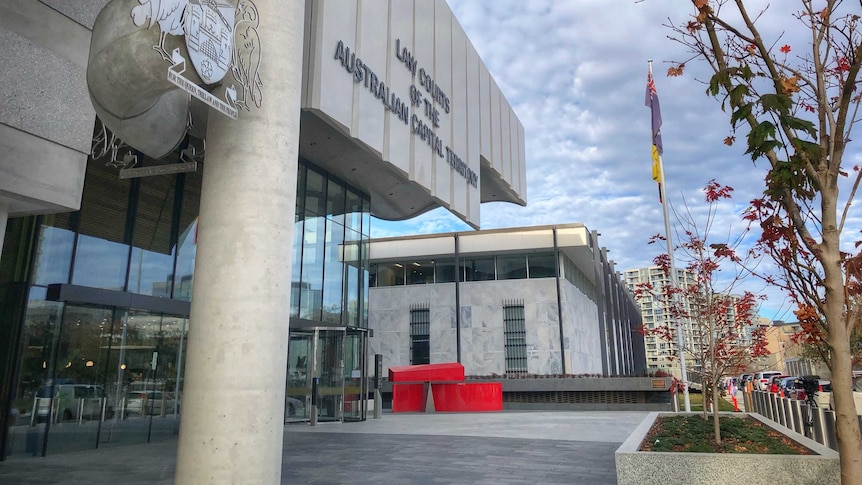 The exterior of the court, showing the sign and the crest.