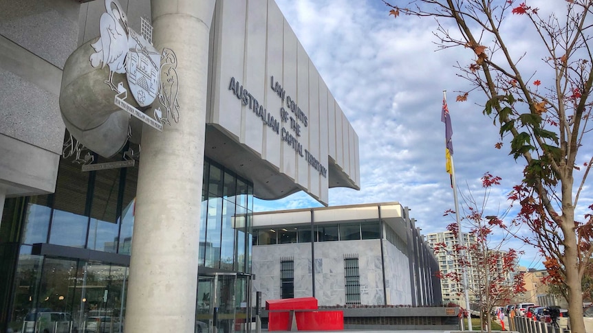 The exterior of the court, showing the sign and the crest.