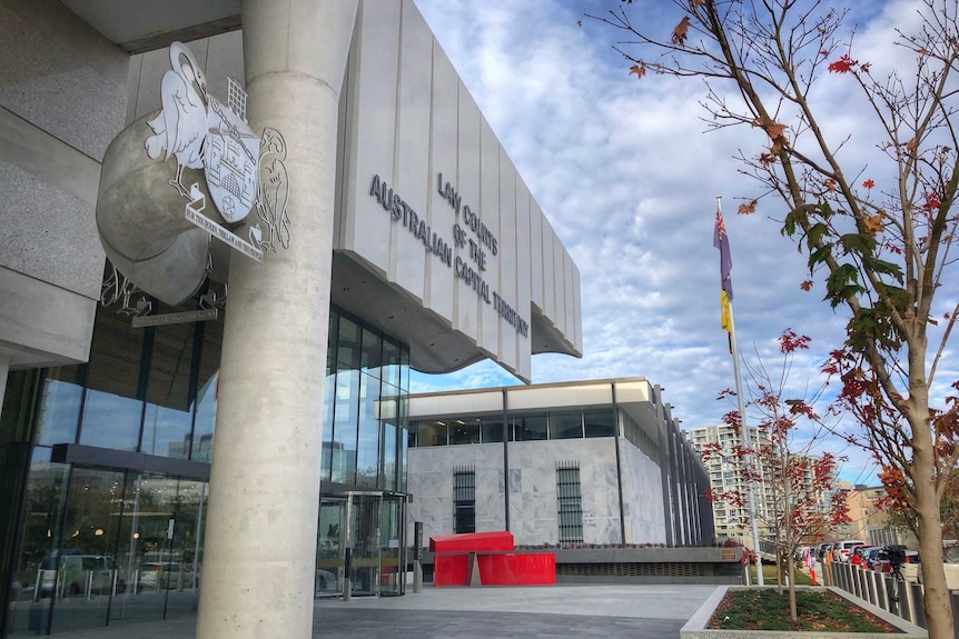 The exterior of the court, showing the sign and the crest.