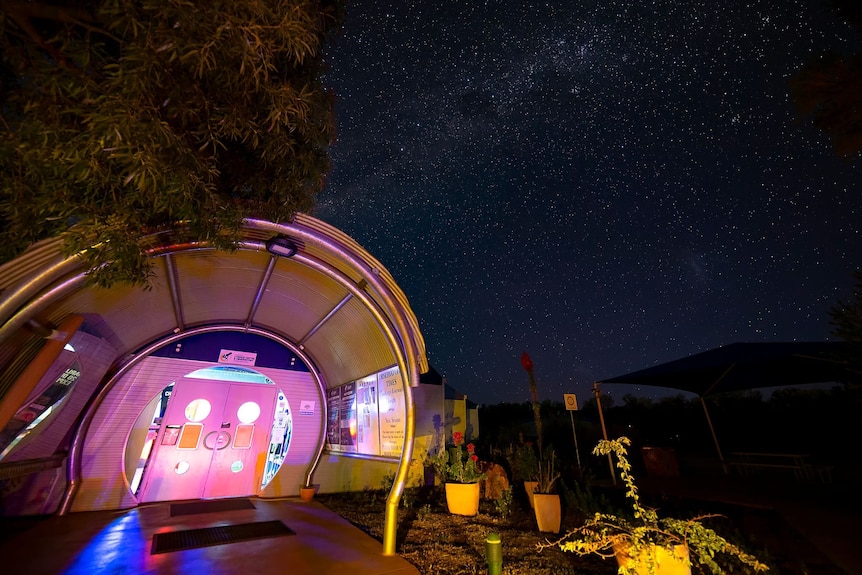 A colourful museum building is lit up at night.