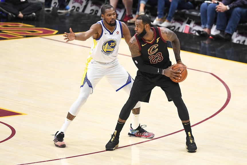 Kevin Durant of the Golden State Warriors defends LeBron James of the Cleveland Cavaliers during the NBA finals.