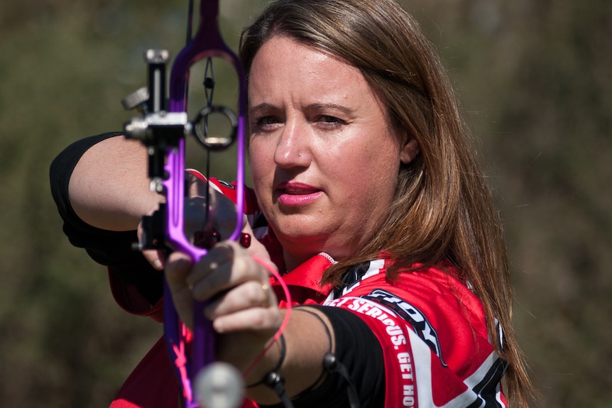 Lisa Scott lines up a target with her compound archery bow.
