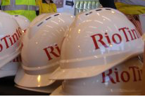Rio Tinto hardhats sit on a table