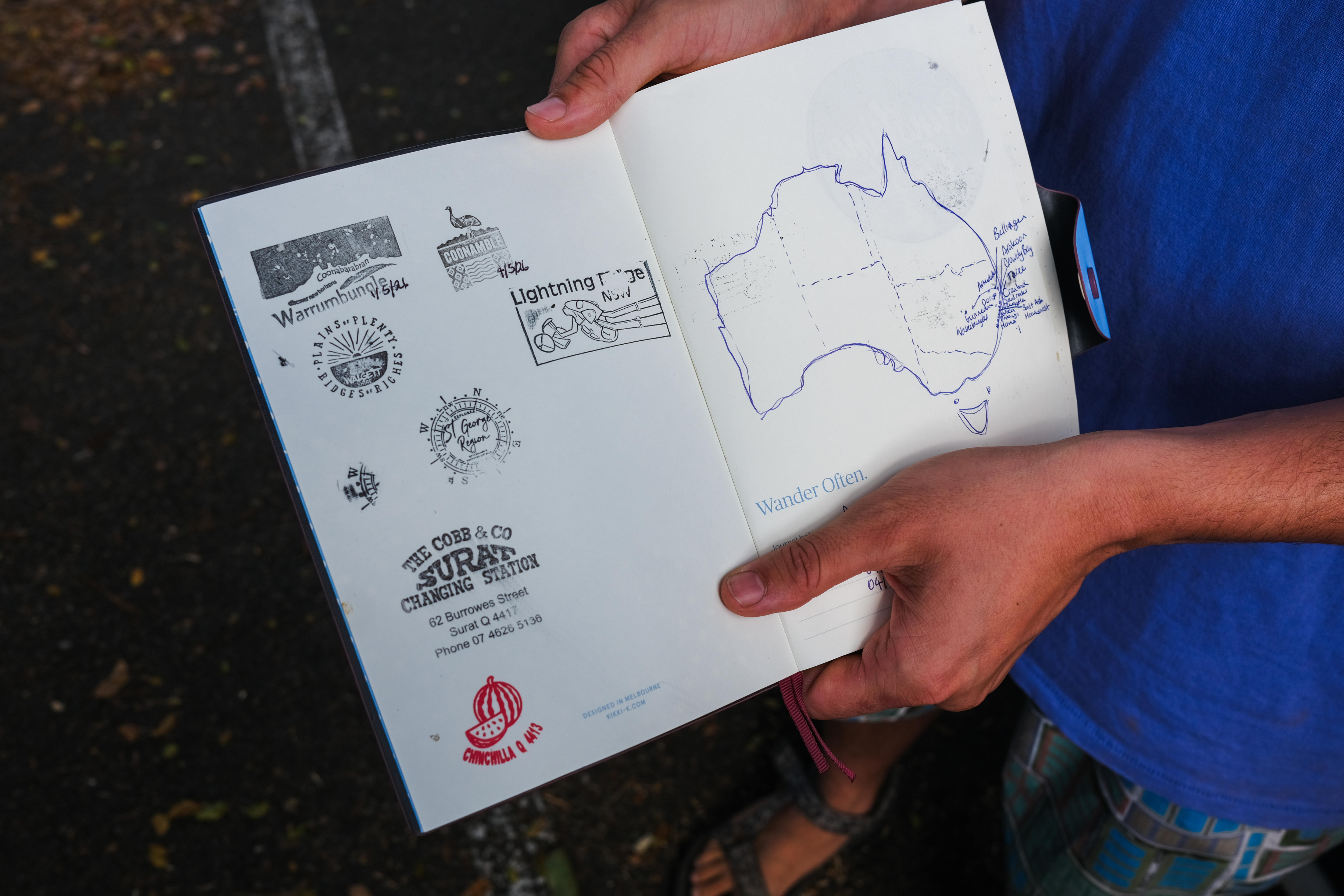 A book with some stamps and a hand-drawn map of Australia