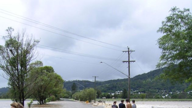 Locals stand on the road from Kyogle to Geneva
