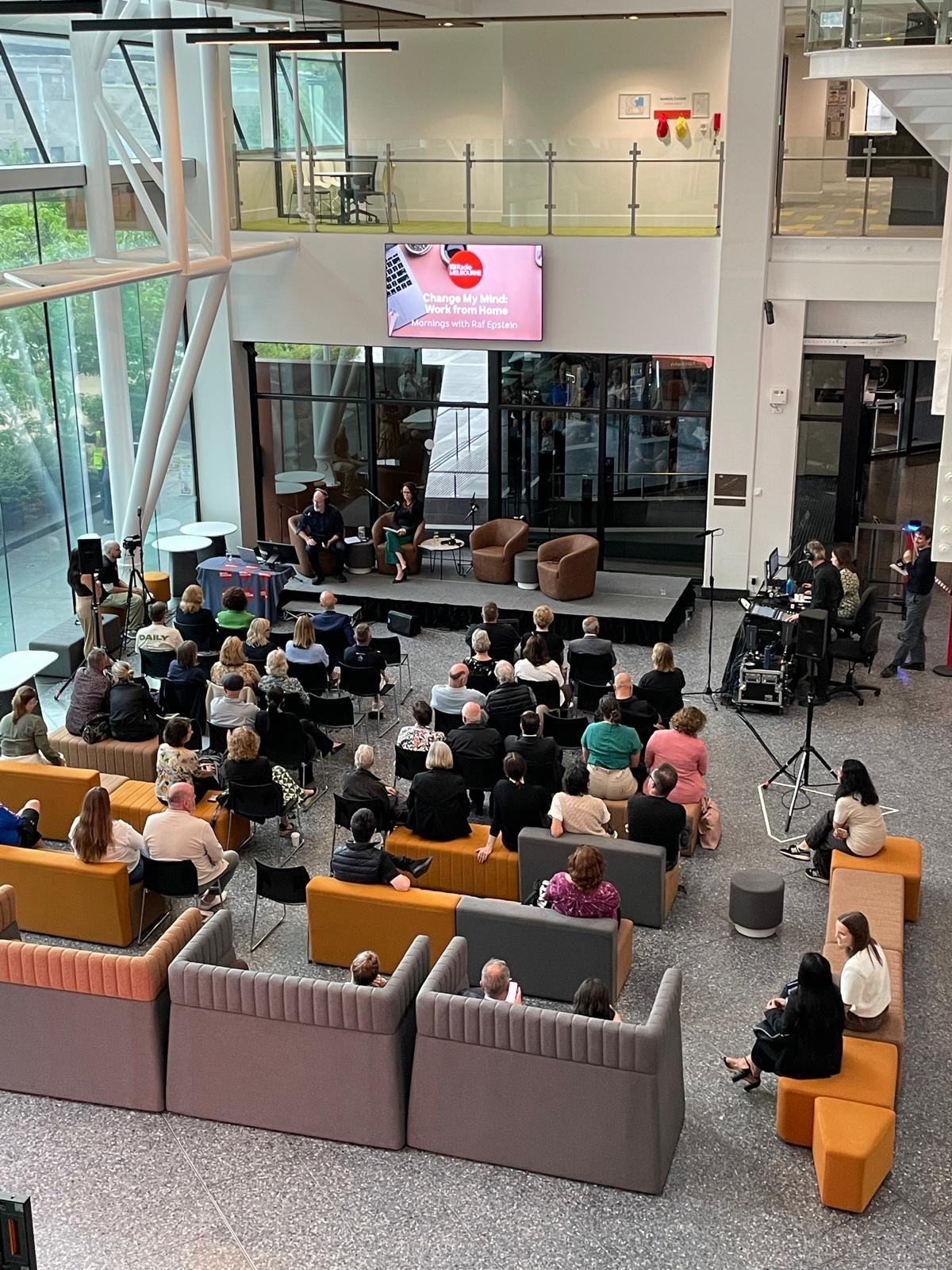 a crowd in front of a stage with a man on it