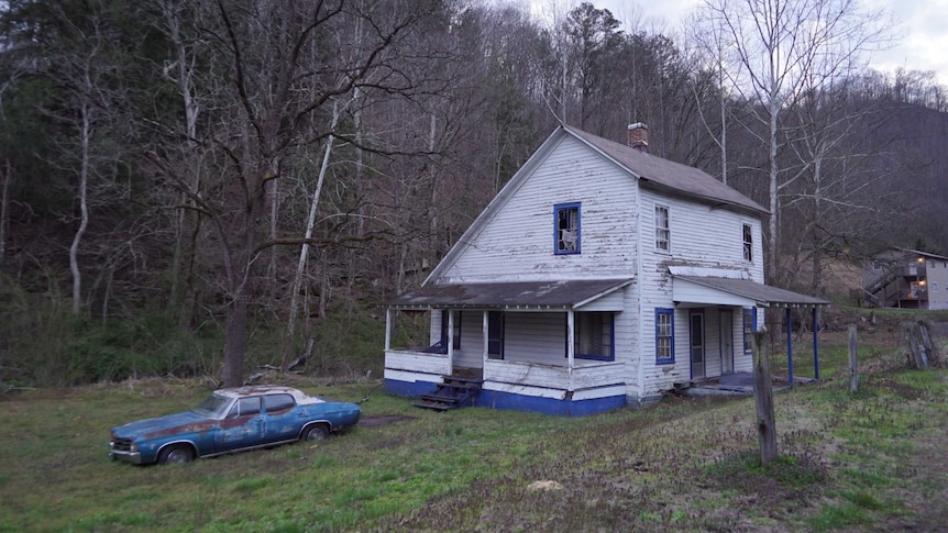 A white dilapidated wooden house in the small town of Chattaroy in middle america coal country