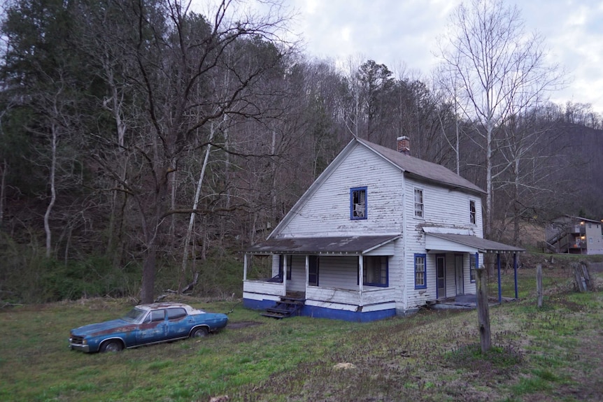 A white dilapidated wooden house in the small town of Chattaroy in middle america coal country