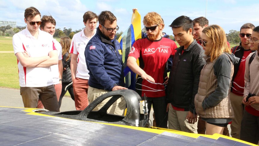Teams talk over a solar car