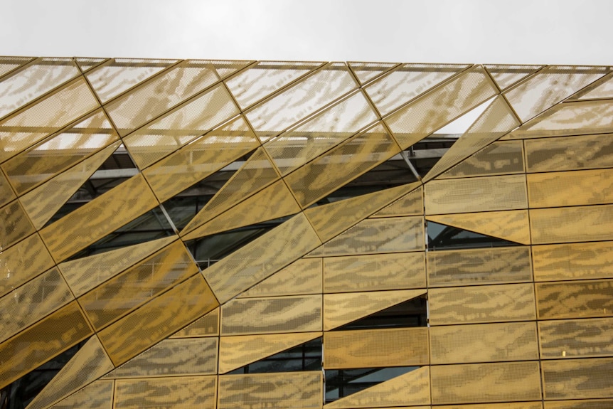 The gold panels on the outside of the Ngoolark building