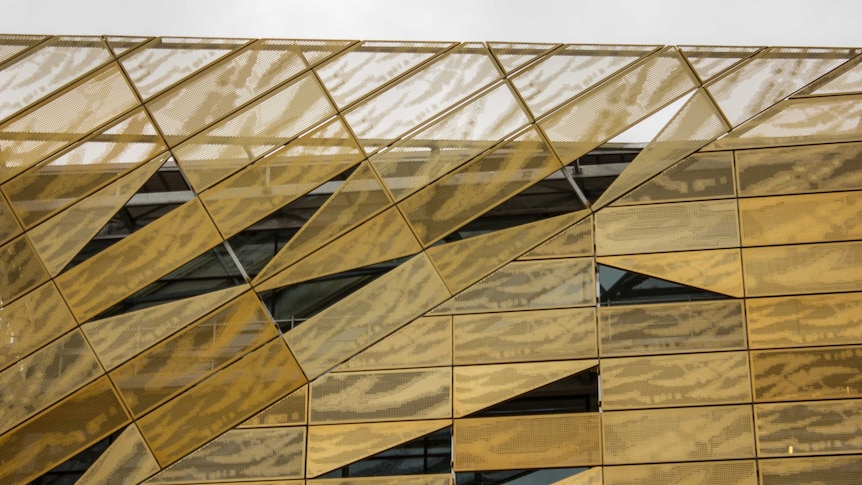 The gold panels on the outside of the Ngoolark building