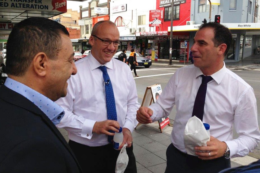 NSW Opposition Leader Luke Foley and Lakemba candidate Jihad Dib chat to a local in Punchbowl