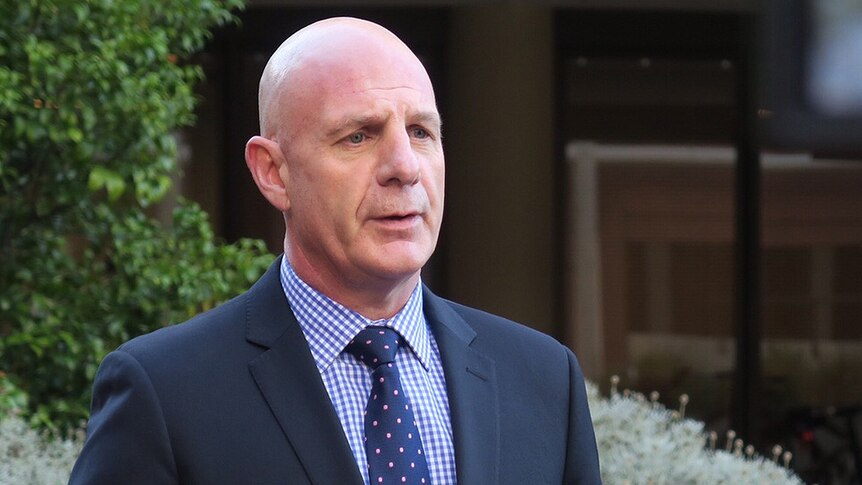 Tasmanian Treasurer Peter Gutwein holding an outdoor press conference.
