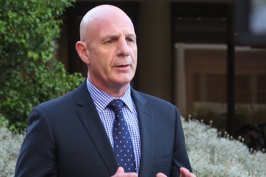 Tasmanian Treasurer Peter Gutwein holding an outdoor press conference.