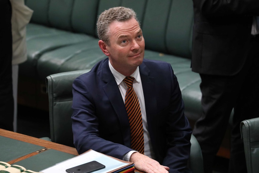 Christopher Pyne sitting in the leader's seat in the House of Representatives looks up to the Speaker, who is not pictured