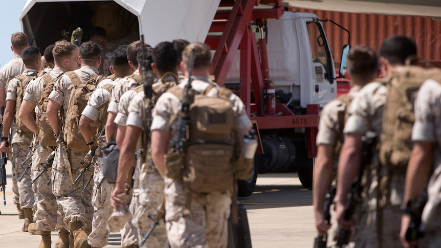 US Marine Corps make their way to board an awaiting aircraft at RAAF Base, as they depart Darwin for the final time in 2017.
