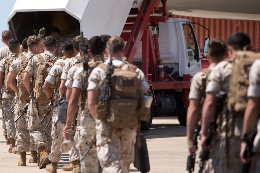 US Marine Corps make their way to board an awaiting aircraft at RAAF Base, as they depart Darwin for the final time in 2017.