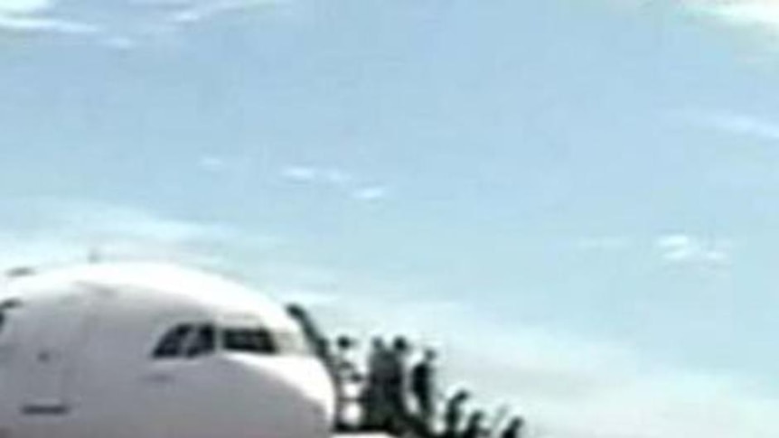 Buckle up ... passengers disembark after mid-air drama