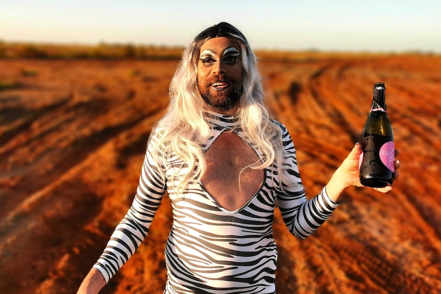 Karratha local Rhys Heland, wearing a zebra-print dress and in drag make-up