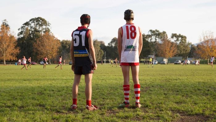 country footy players watch on