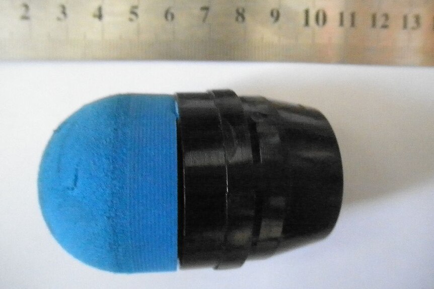 A sponge grenade - a black foam round on top of a base.