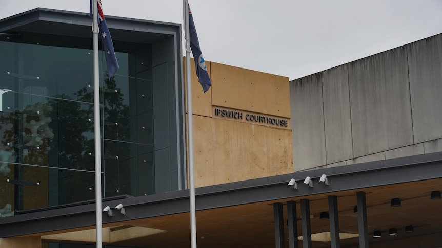 Exterior of Ipswich court building with two flags out the front