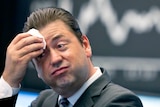 A stock trade reacts at the stock market in the central German city of Frankfurt