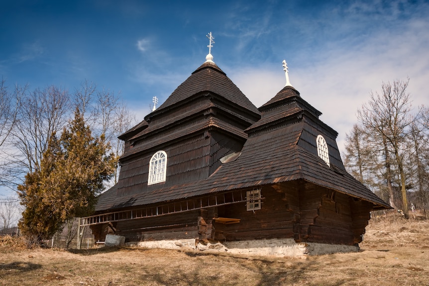 A wooden church painted black.