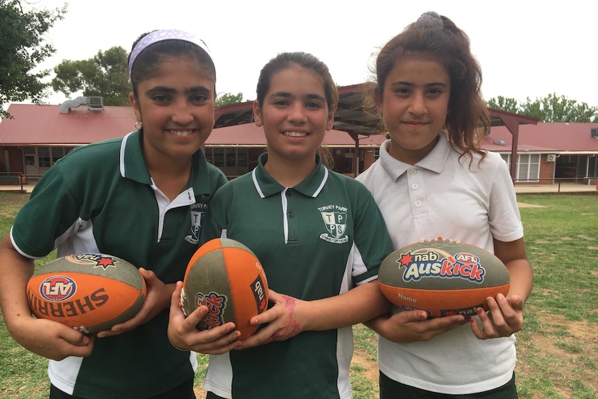 (L-R) Rozaliya Hasan, Shireen Khaltie and Narmin Kambar from Iraq are taking part in an AFL program in Wagga Wagga