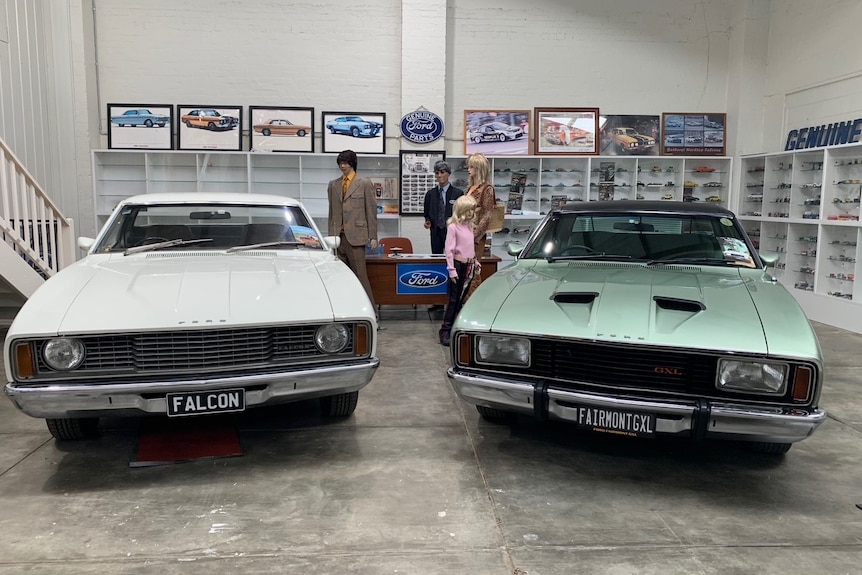 two wide fords parked nect to each other. One is white, one is lime green.