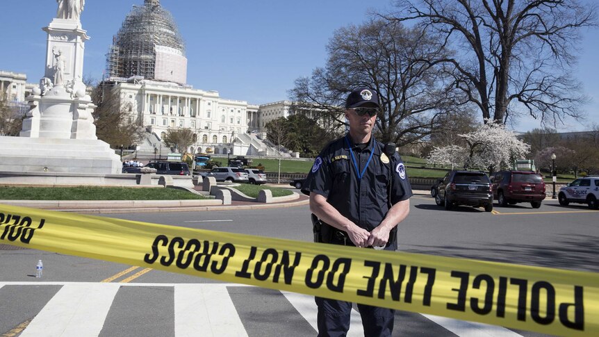Police guard the US Capitol building after shooting incident