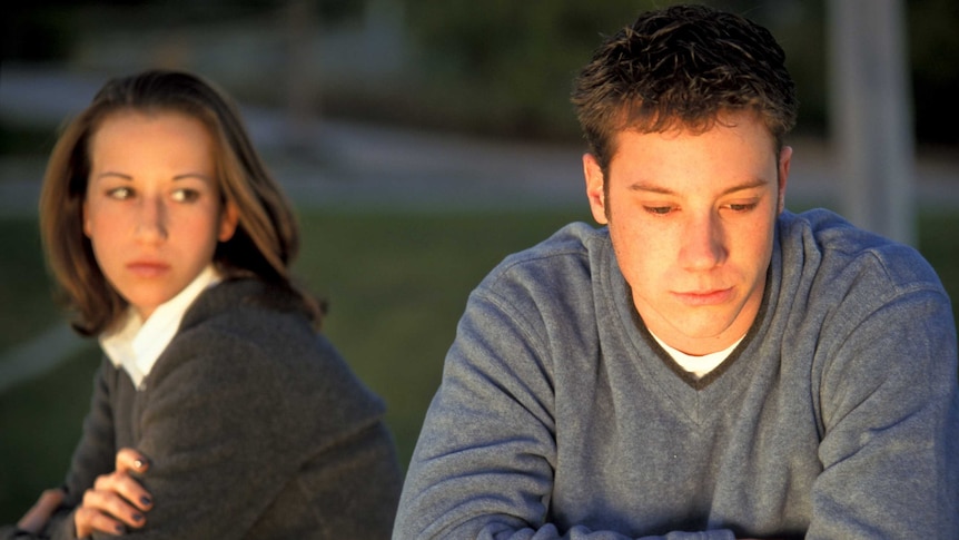 Two moody looking teenagers